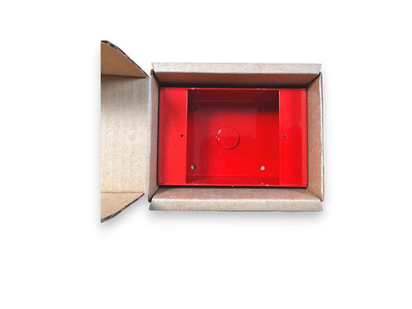 Red fire alarm pull station box in open cardboard packaging