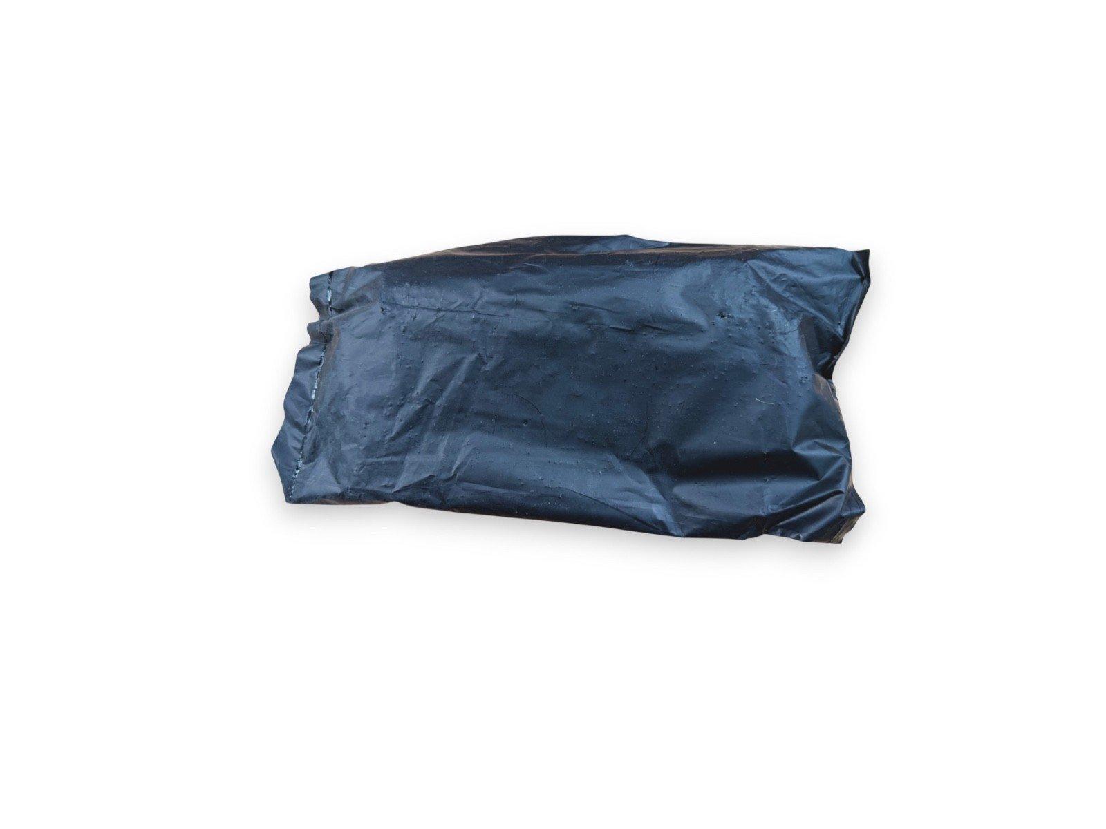 Black plastic-wrapped fire alarm equipment package on white background