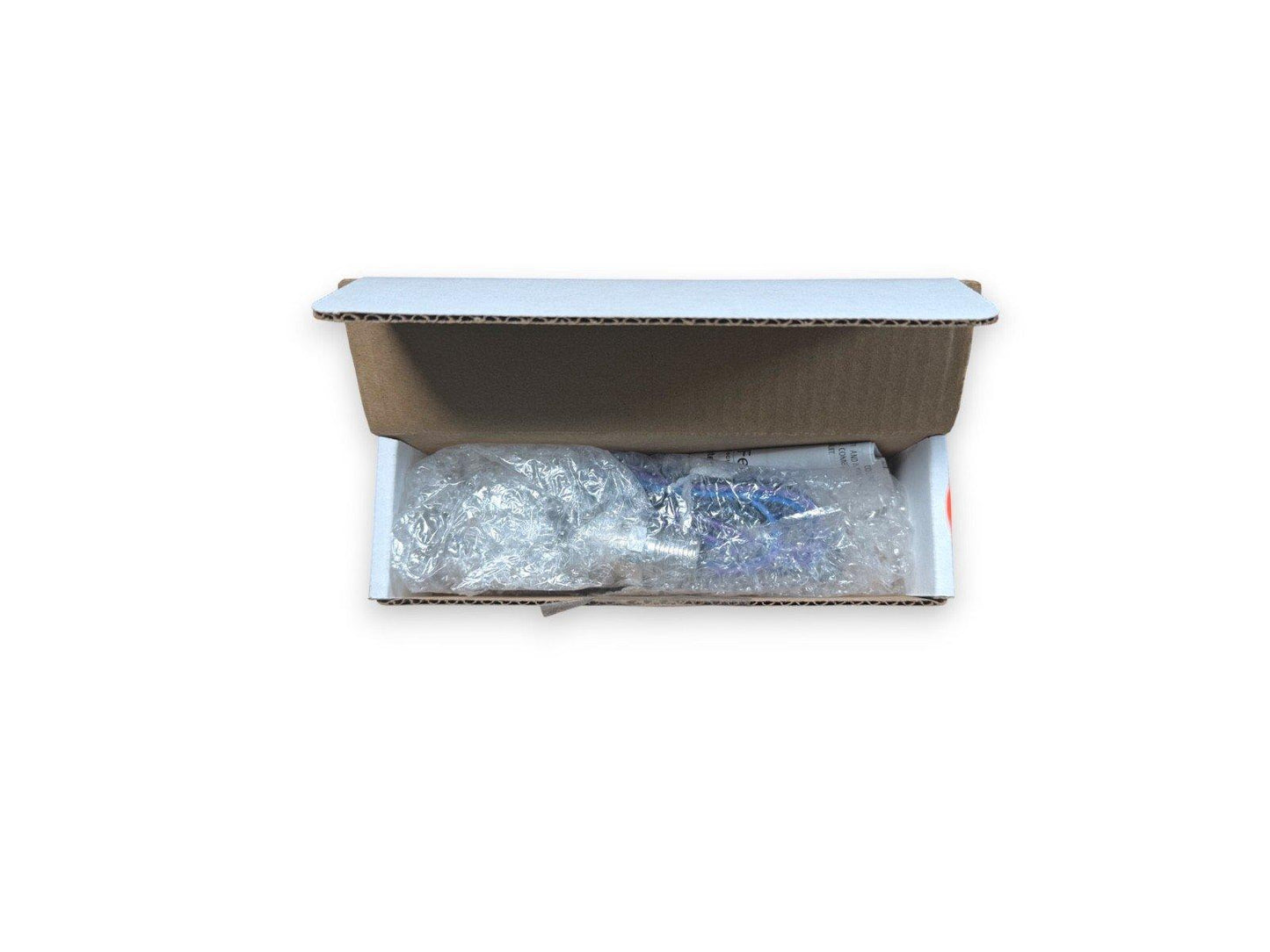 Fire alarm equipment packaged in bubble wrap inside a cardboard box for safe shipping