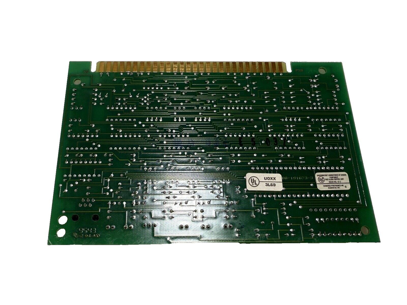 Green fire alarm control panel circuit board with UL certification labels and gold edge connector