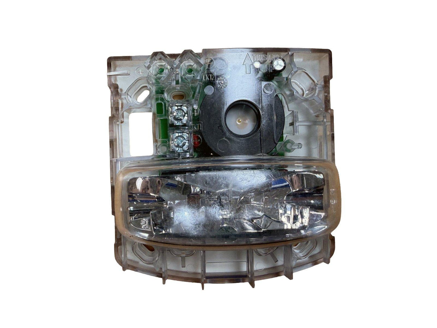 Clear fire alarm strobe light with internal circuitry and speaker, labeled 'THIS END UP' for installation