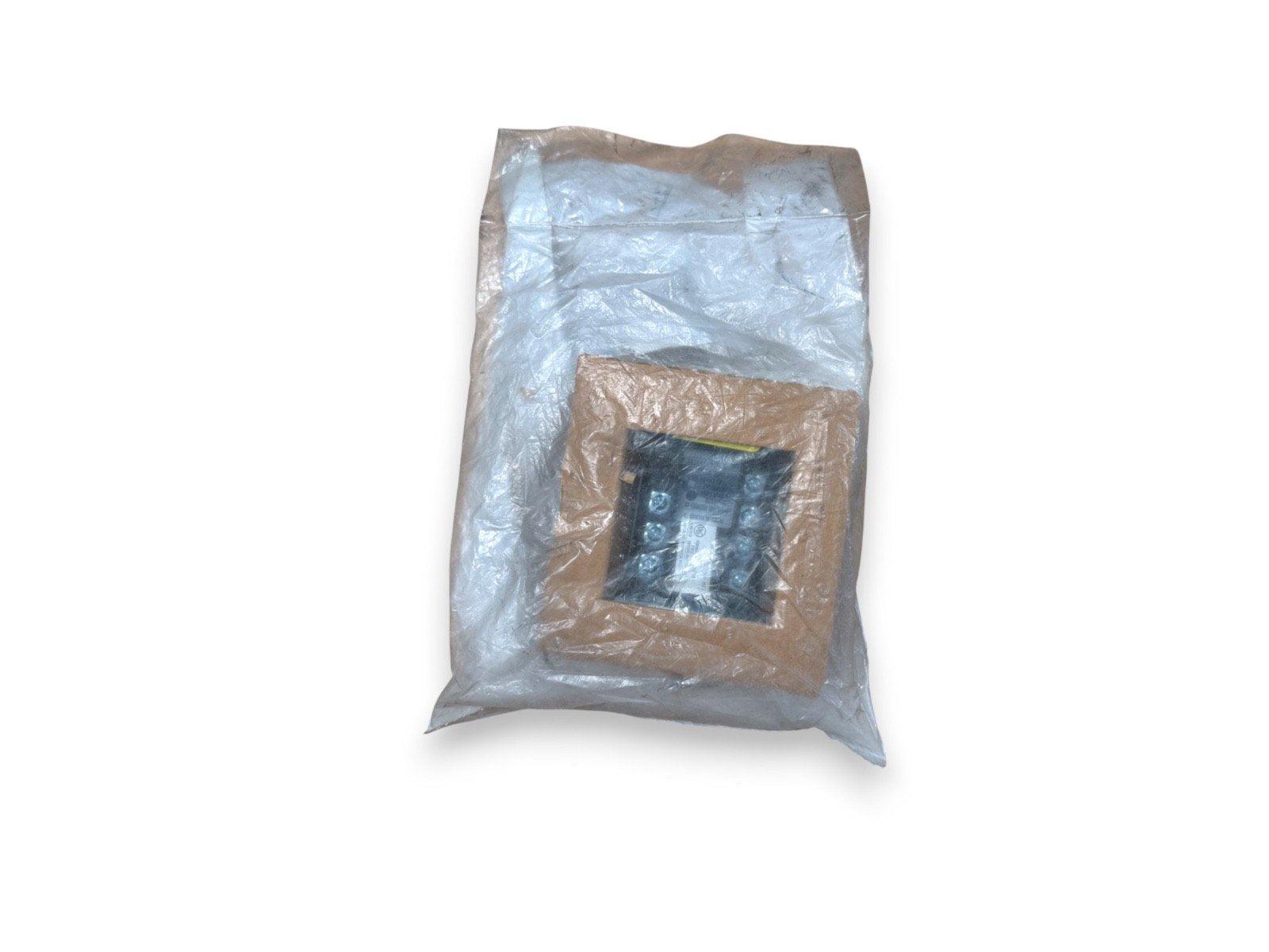 Fire alarm control module in protective plastic wrap, ready for installation or shipping