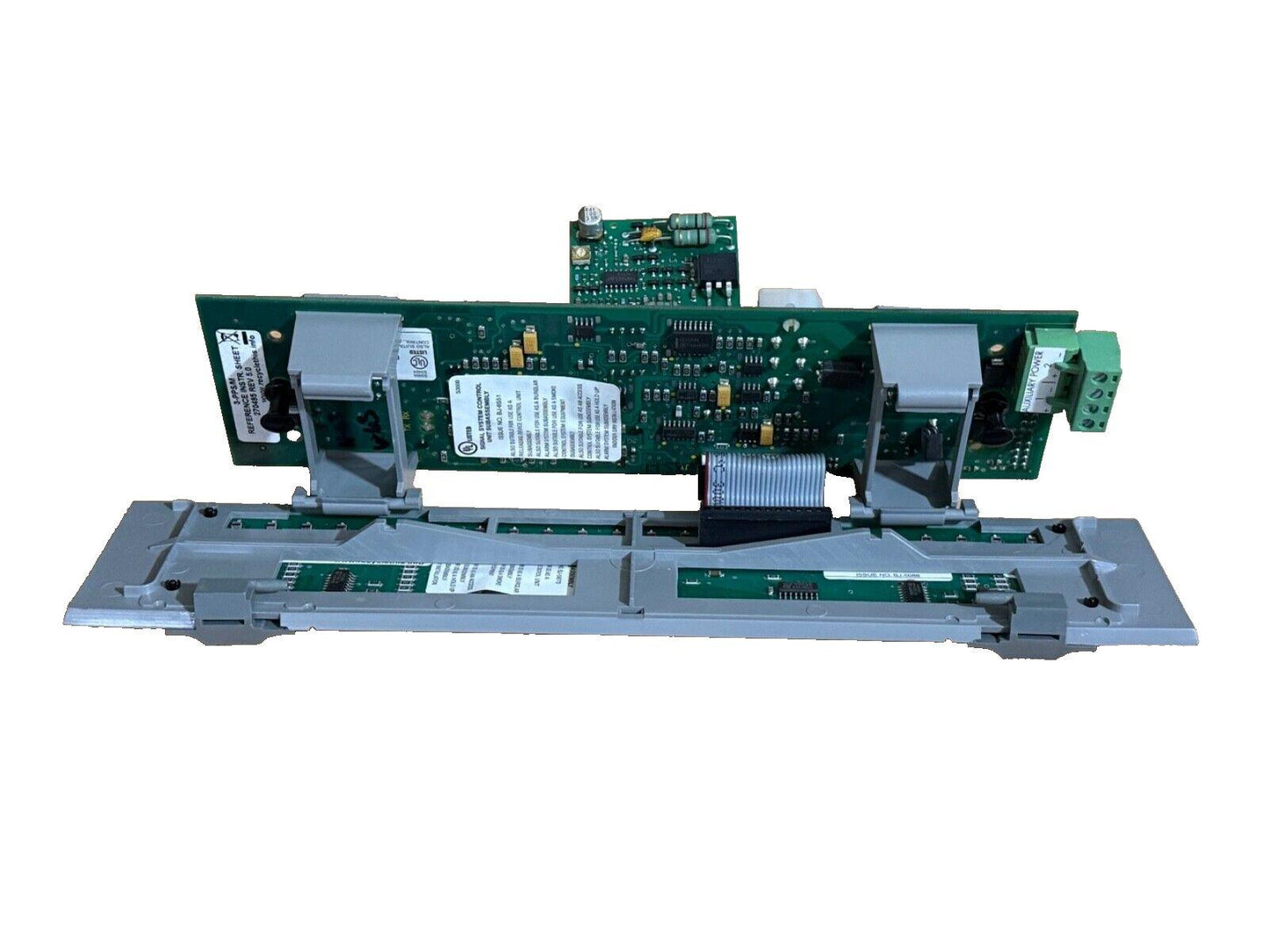 Fire alarm control panel circuit board with green PCB and terminal connectors for system integration
