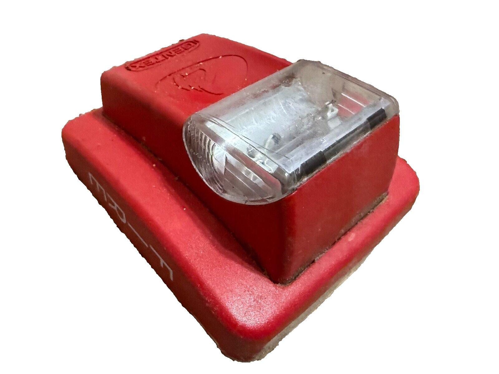 Red fire alarm strobe light with clear lens, used fire safety equipment