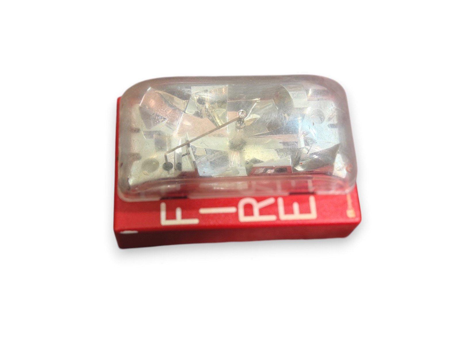 Red fire alarm strobe light with clear cover, used in commercial fire safety systems