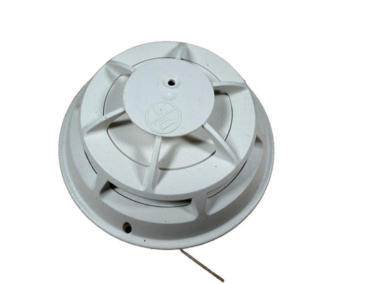 White ceiling-mounted fire alarm detector with wiring, for commercial or residential safety systems