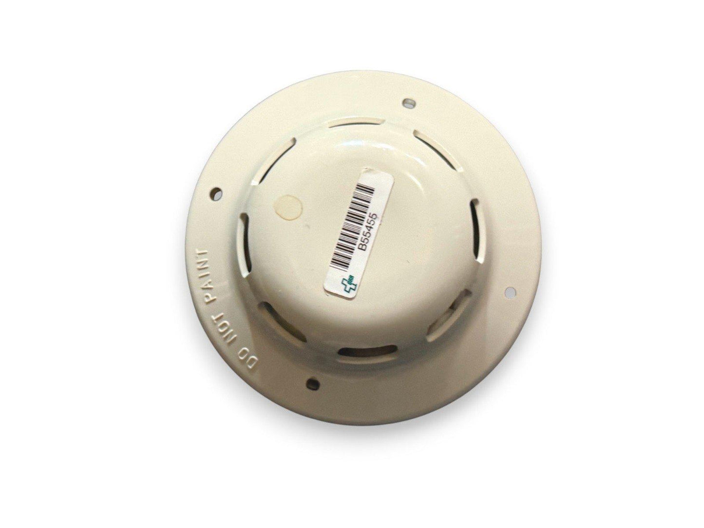 Beige fire alarm detector with barcode label, ceiling-mounted safety device for fire protection systems