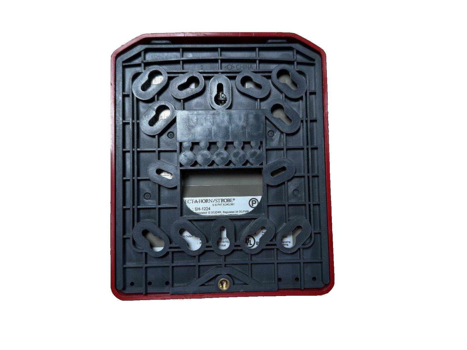 Back view of fire alarm horn strobe device with mounting holes and label, model SH-1224