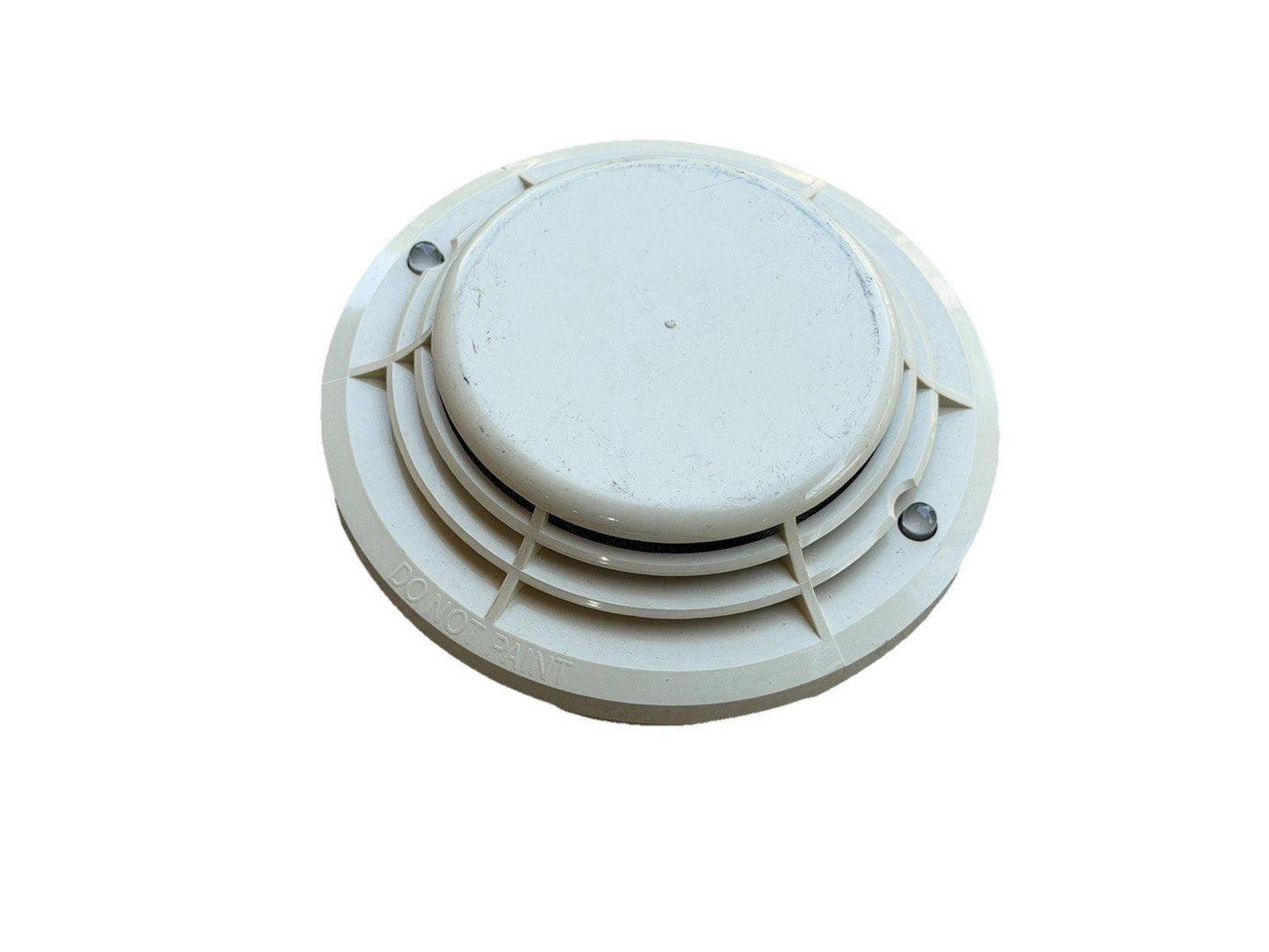 White ceiling-mounted smoke detector with 'DO NOT PAINT' label, fire alarm safety device