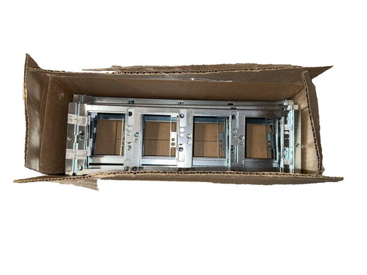 Fire alarm control panel modules in open cardboard box, metallic housing with UL labels visible