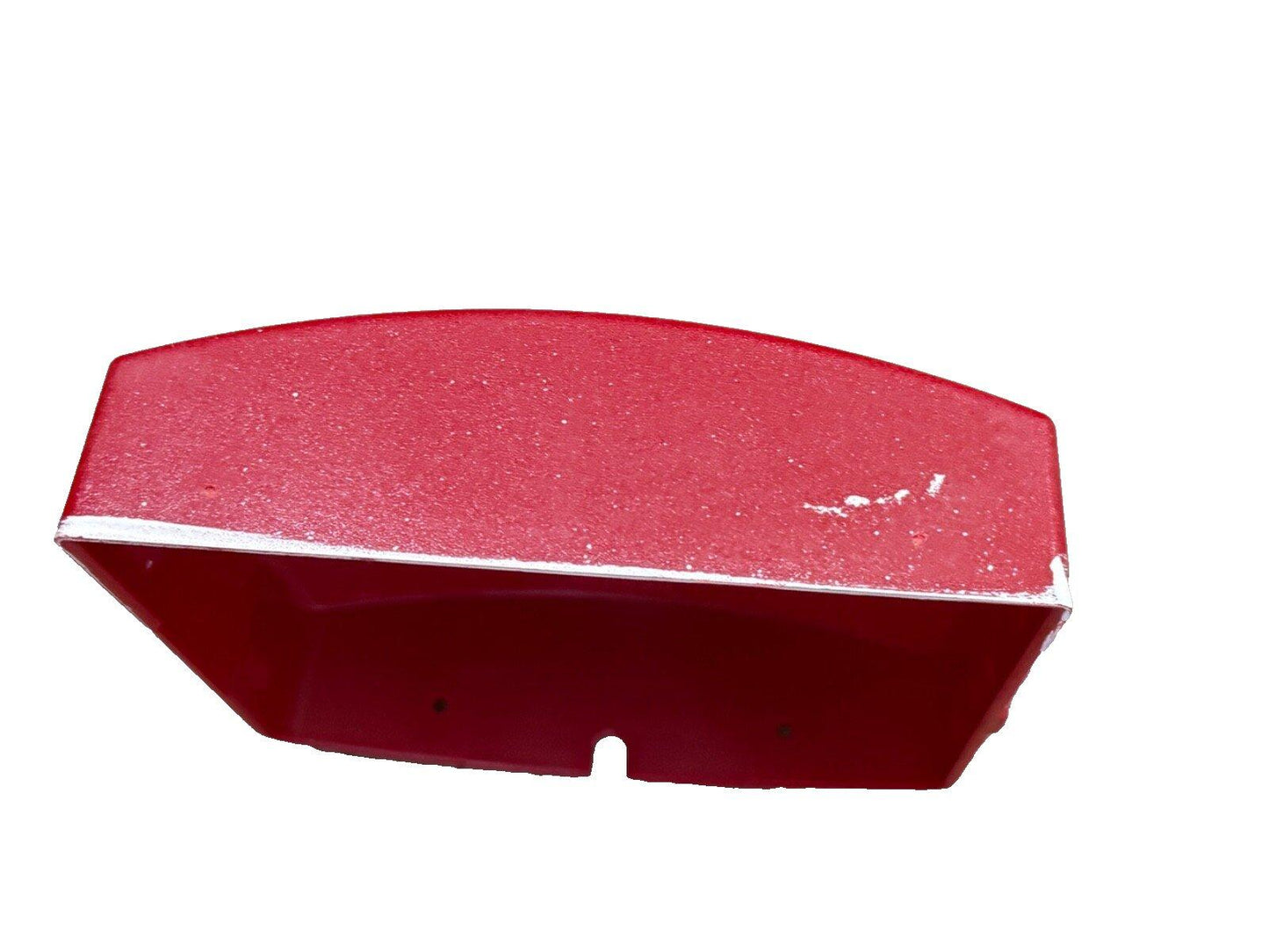 Red fire alarm bell cover with textured surface and mounting holes