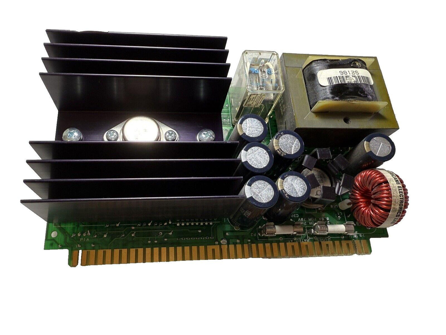 Fire alarm control panel circuit board with heatsink, capacitors, and transformer for fire safety systems