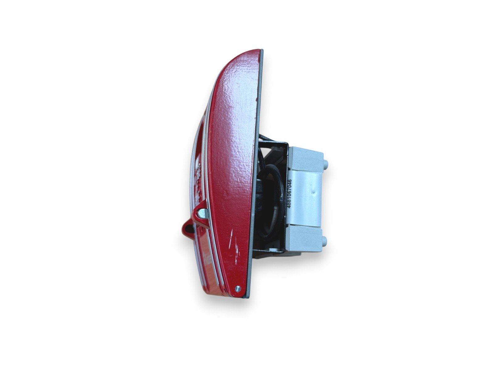 Red fire alarm horn strobe with visible wiring and mounting base, used fire safety equipment