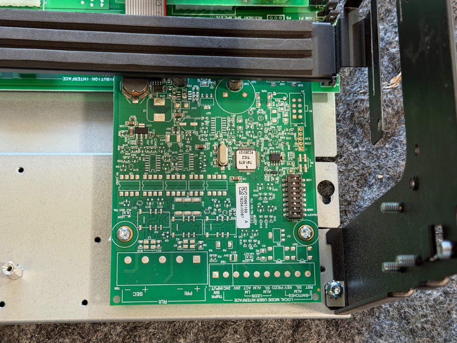 Fire alarm control panel circuit board with green PCB and interface connectors