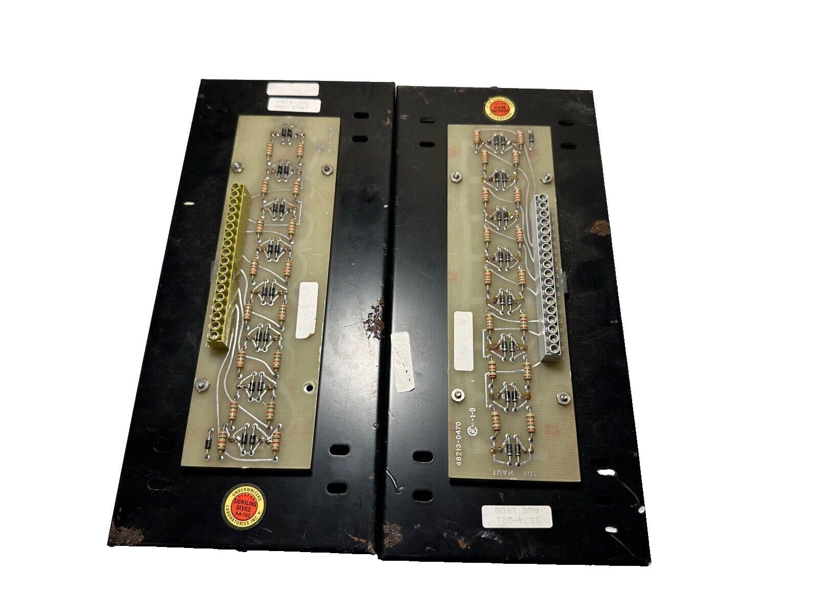 Used fire alarm control panels with circuit boards, resistors, and UL labels for commercial safety systems