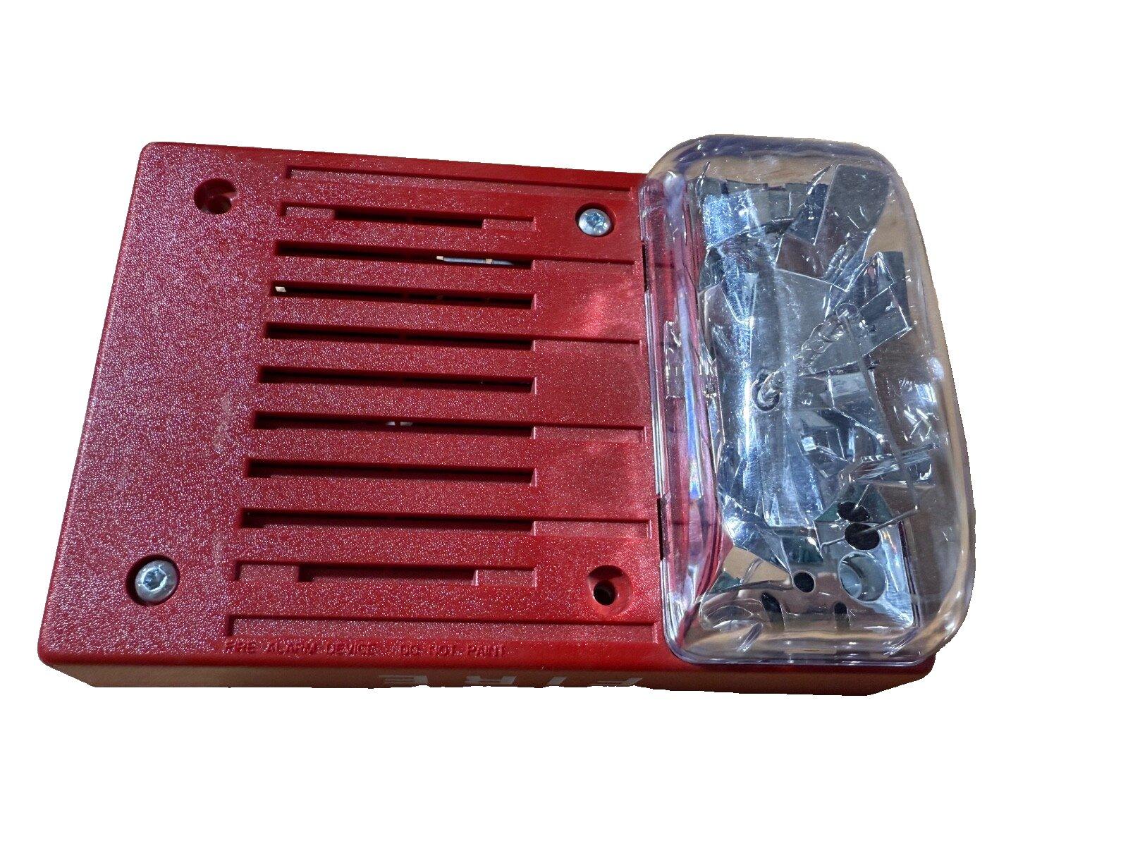 Red fire alarm horn strobe with clear lens, used fire safety equipment