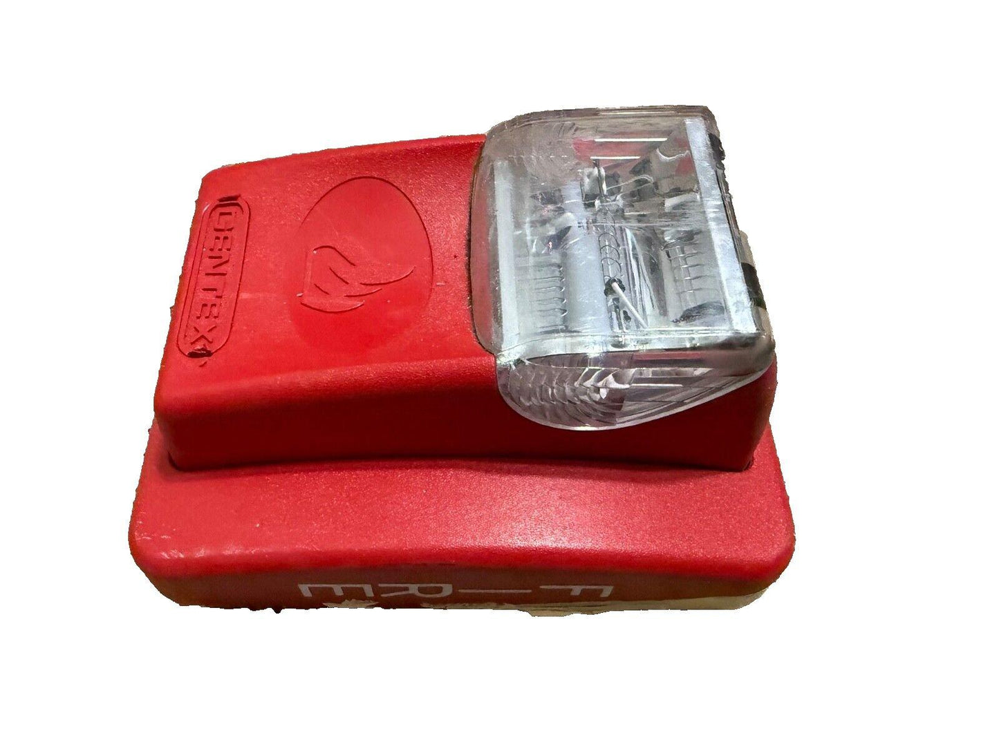 Red Gentex fire alarm strobe light with clear lens, used fire safety equipment