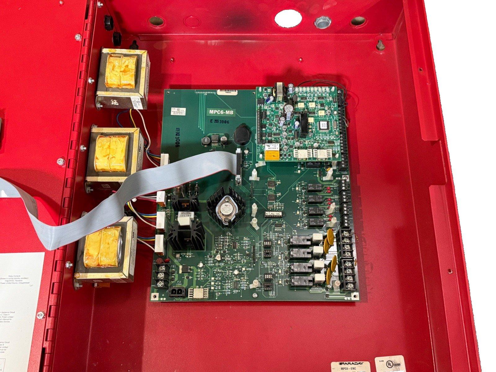 Faraday MPC6-MB fire alarm control panel circuit board inside red enclosure with transformers and wiring
