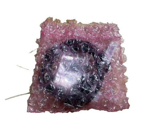 Fire alarm device wrapped in pink bubble wrap for shipping protection