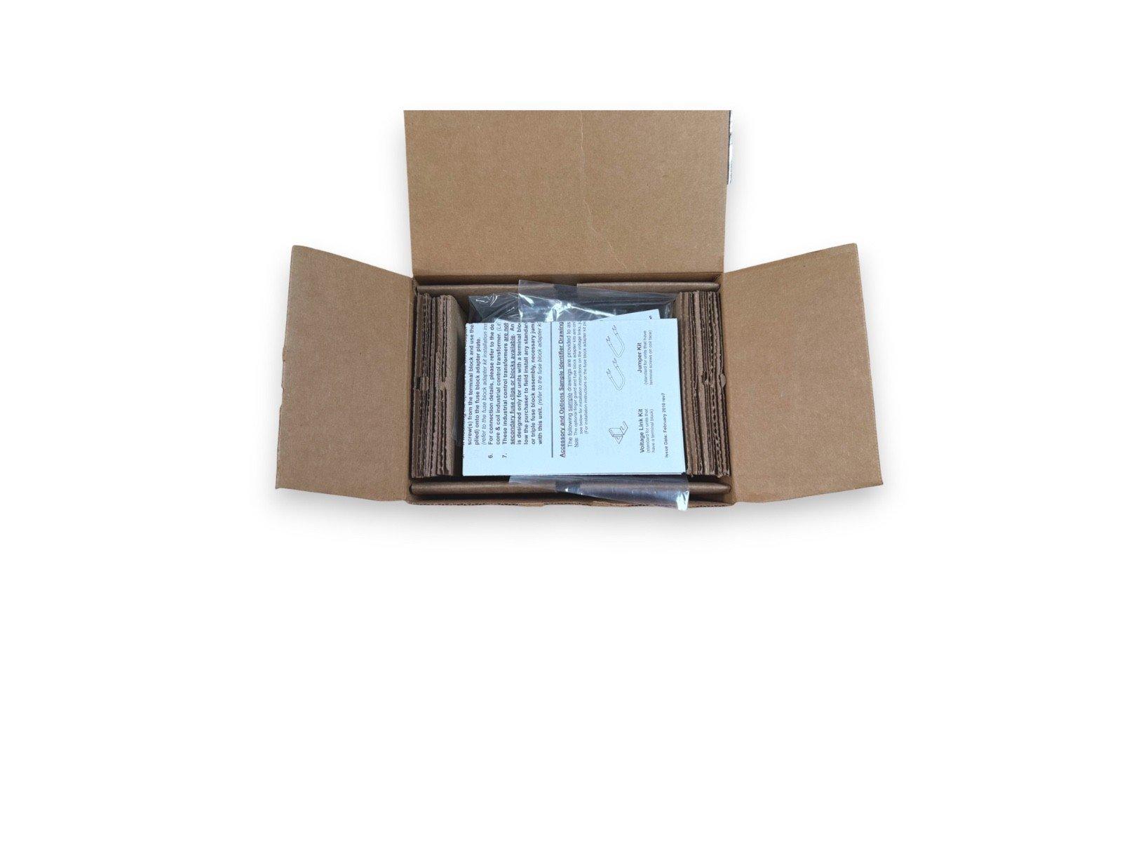 Open box with fire alarm jumper kit and installation instructions inside