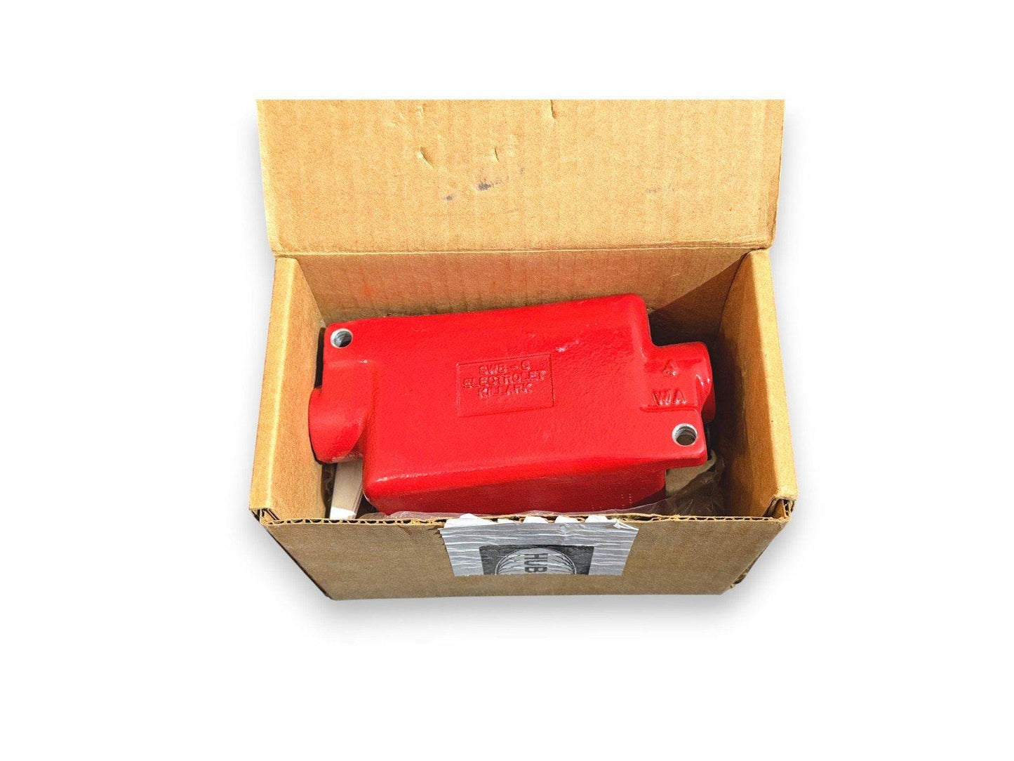 Red fire alarm relay in open cardboard box, labeled SWB-6 Electrolyst Relay for fire safety systems