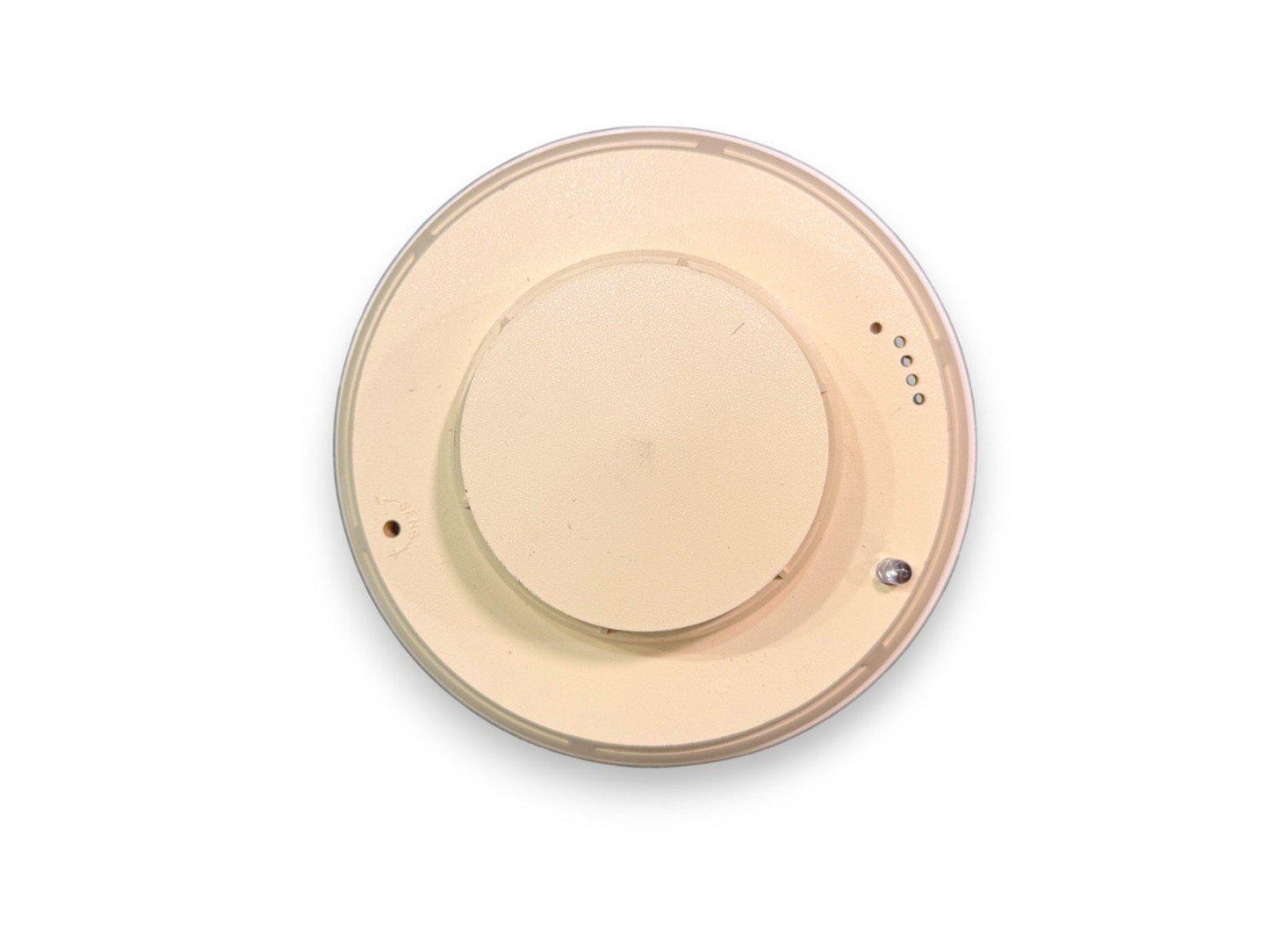 Beige ceiling-mounted fire alarm detector with sensor holes and mounting points