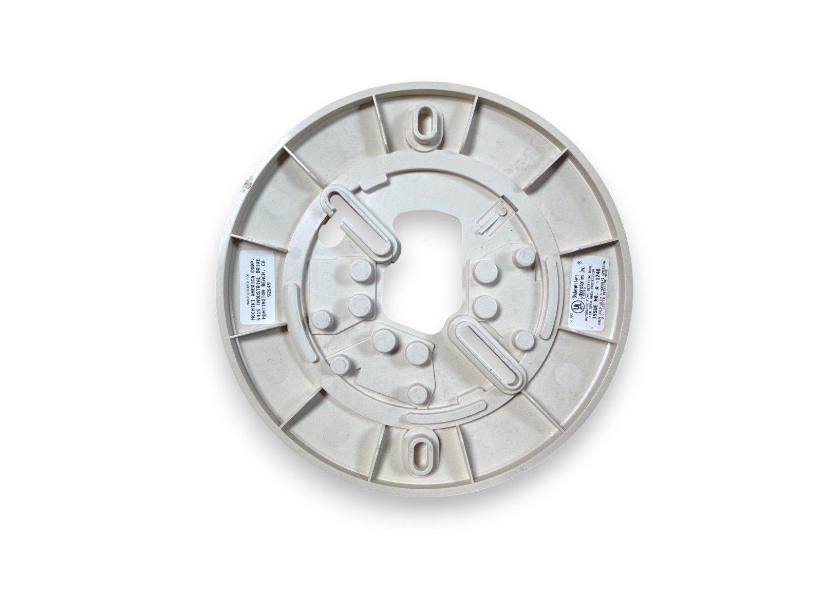 White fire alarm base with mounting clips and labels, compatible with commercial smoke detectors