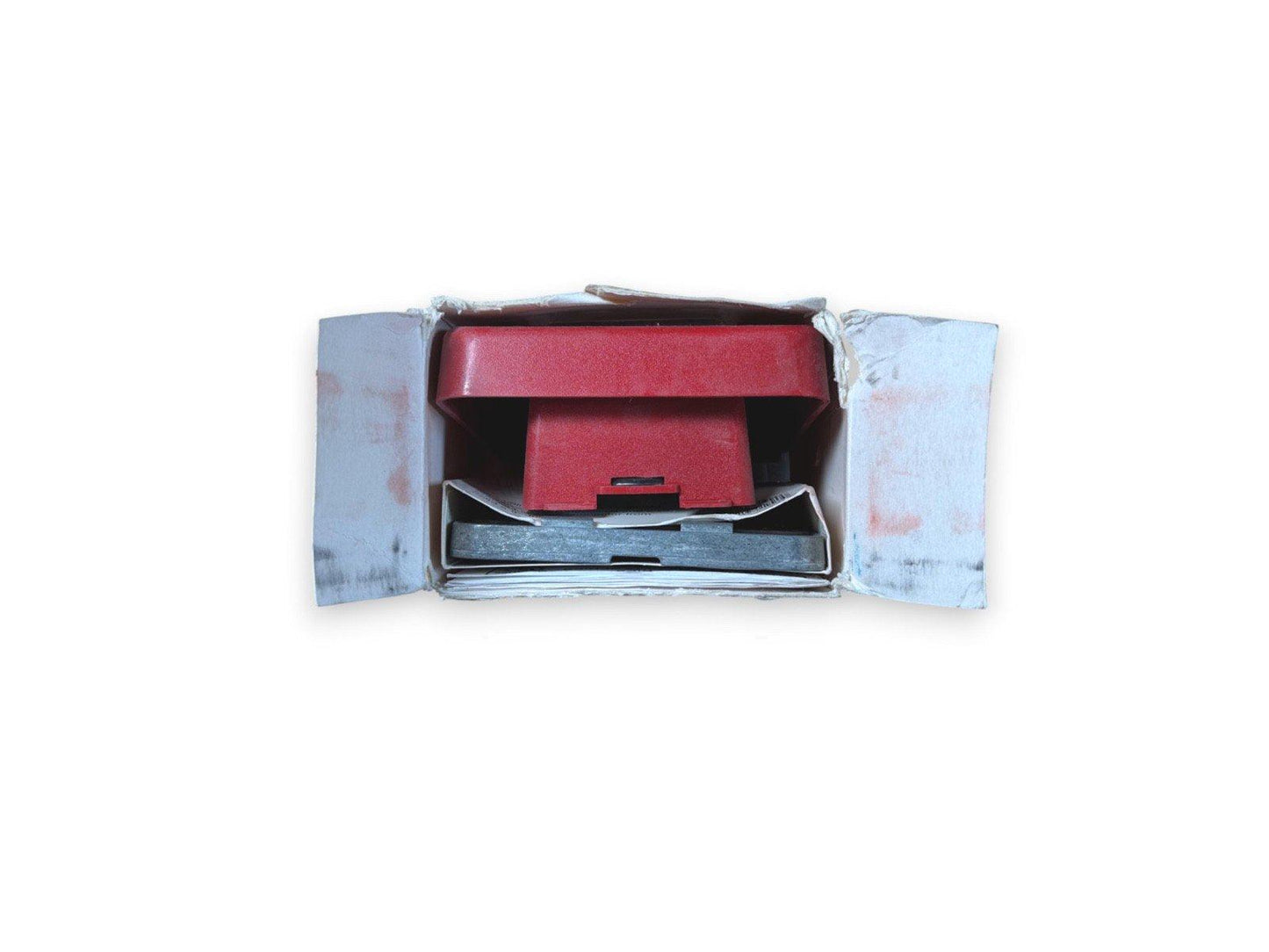 Red fire alarm pull station in open box, used fire safety equipment