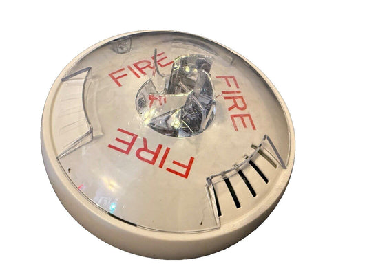 White fire alarm detector with red FIRE text and clear lens, used for smoke and fire safety systems