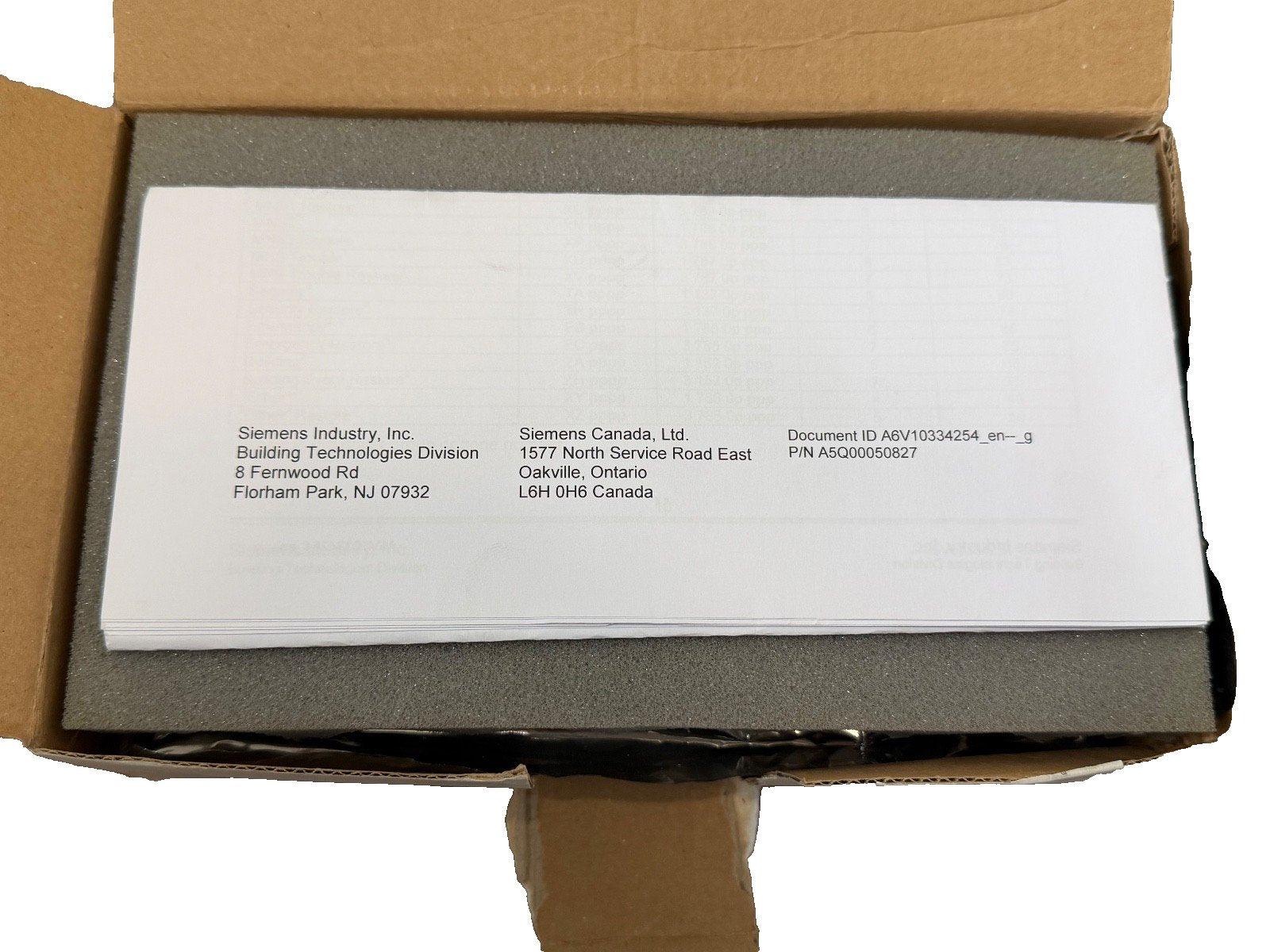 Siemens fire alarm documentation manual in open box with foam padding, part number A5Q00050827