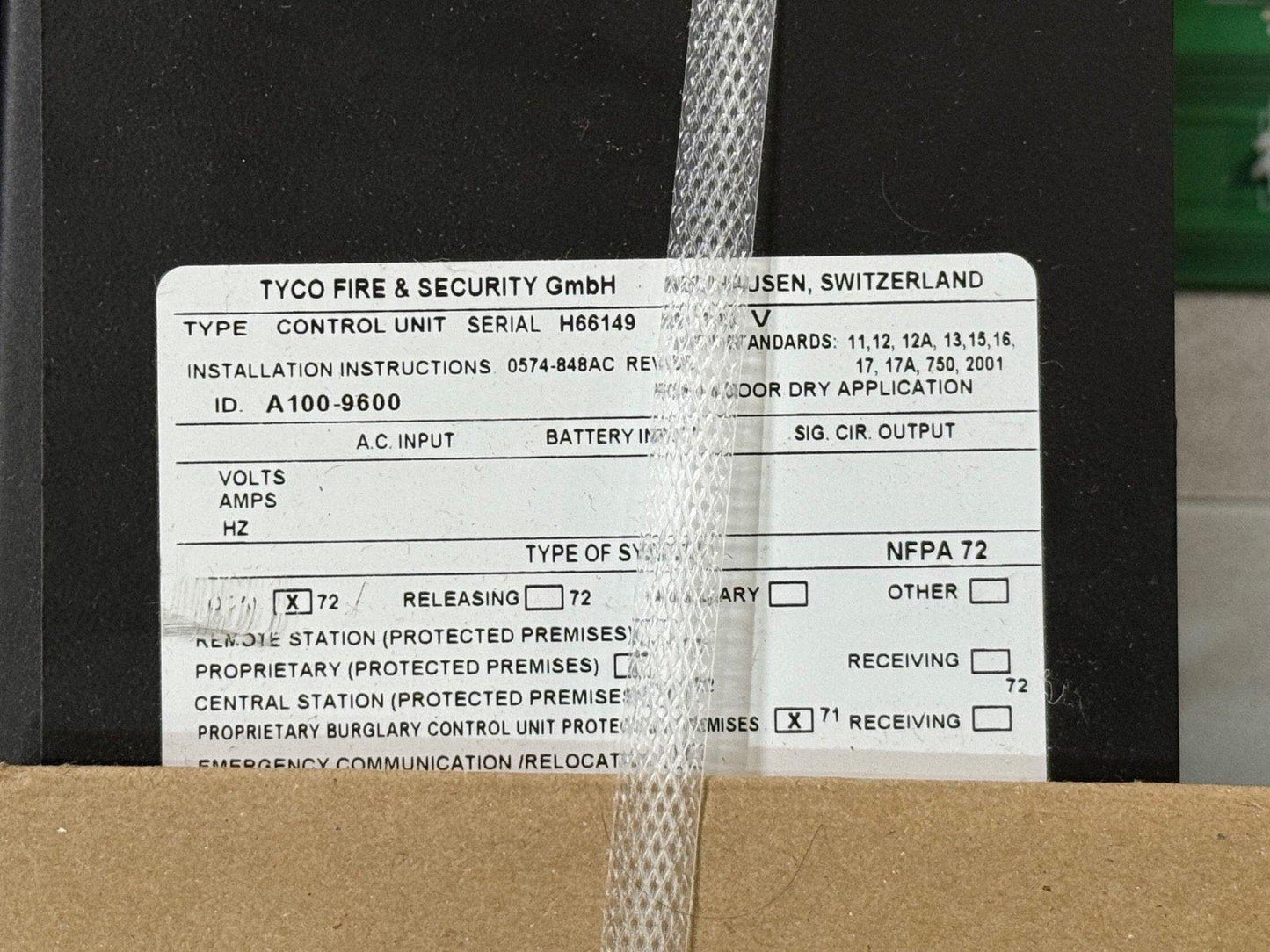 TYCO fire alarm control unit label showing model A100-9600, NFPA 72 compliant, for protected premises systems