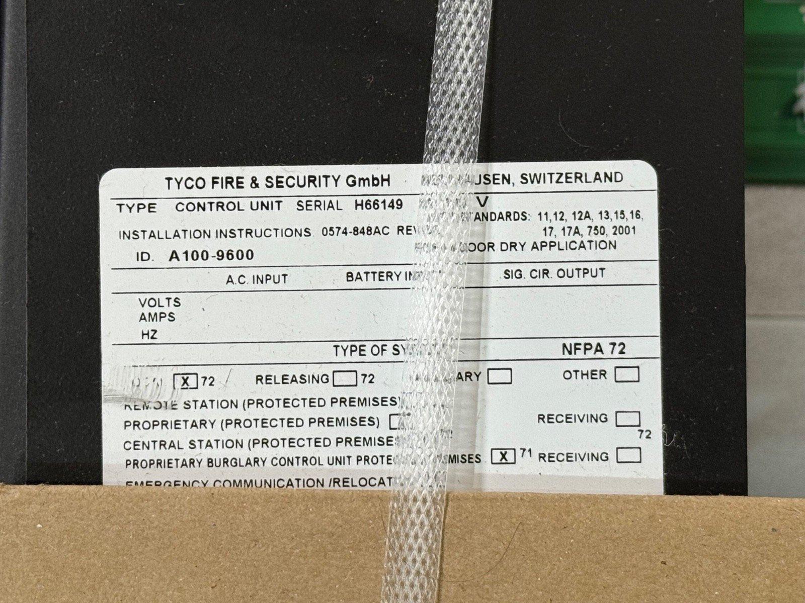 TYCO fire alarm control unit label showing model A100-9600, NFPA 72 compliant, for protected premises systems