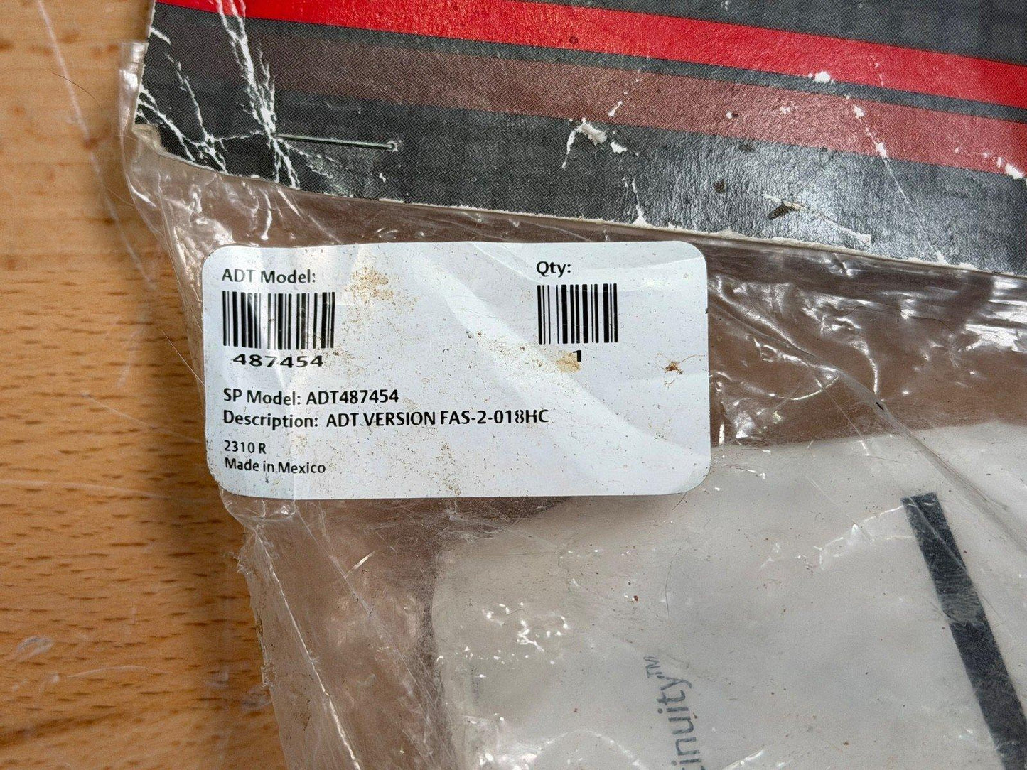 ADT fire alarm part ADT487454 in sealed packaging, model FAS-2-018HC, made in Mexico