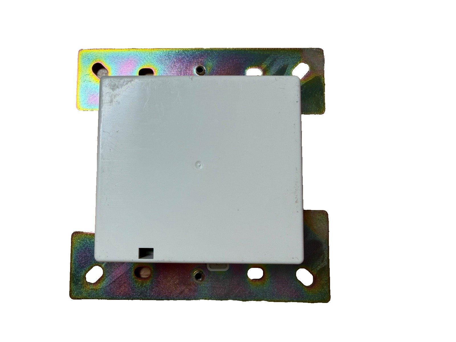 White fire alarm control module with iridescent metal mounting bracket