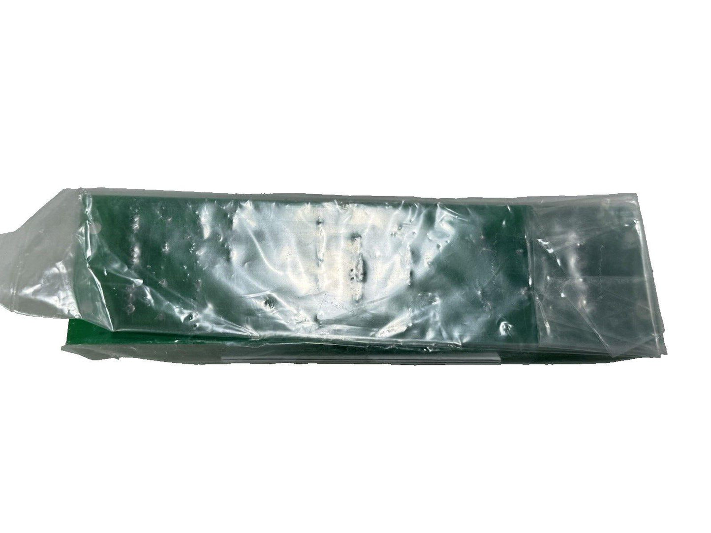 Green fire alarm control panel circuit board in clear plastic packaging