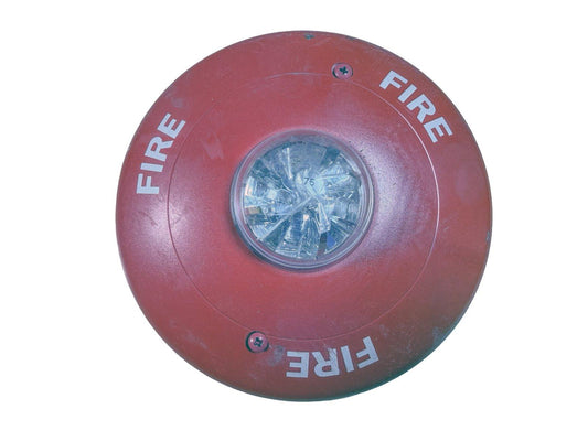 Red fire alarm strobe light with 'FIRE' text, used fire safety equipment