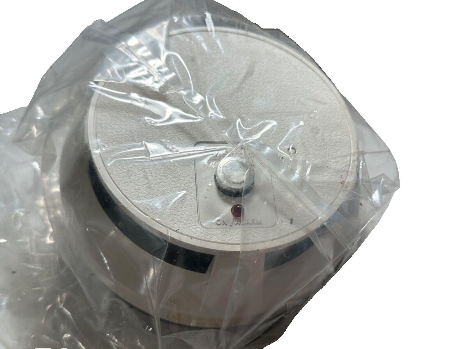 Used fire alarm device in plastic wrap, labeled ON/ALARM, for safety systems