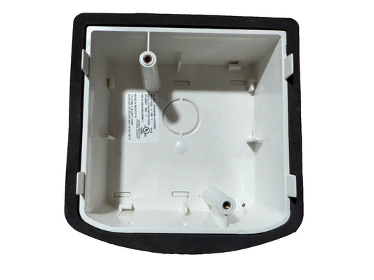White fire alarm base with black mounting frame, showing internal wiring terminals and UL label