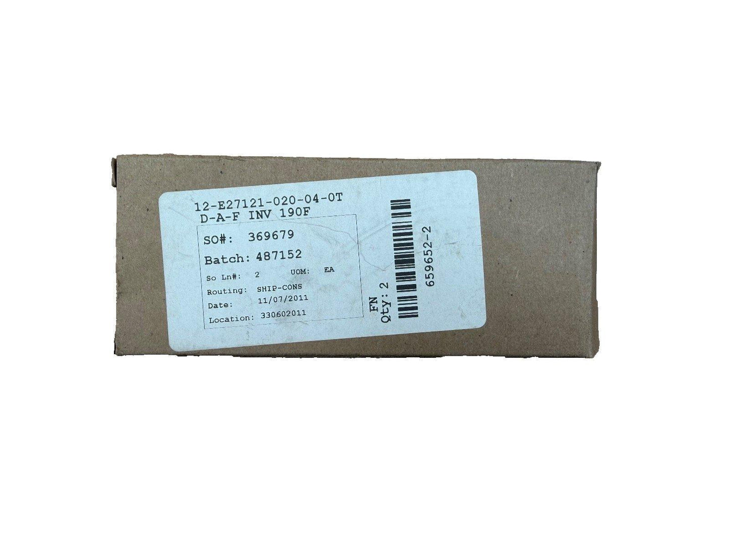 Cardboard box with shipping label for fire alarm equipment, showing part number and batch details