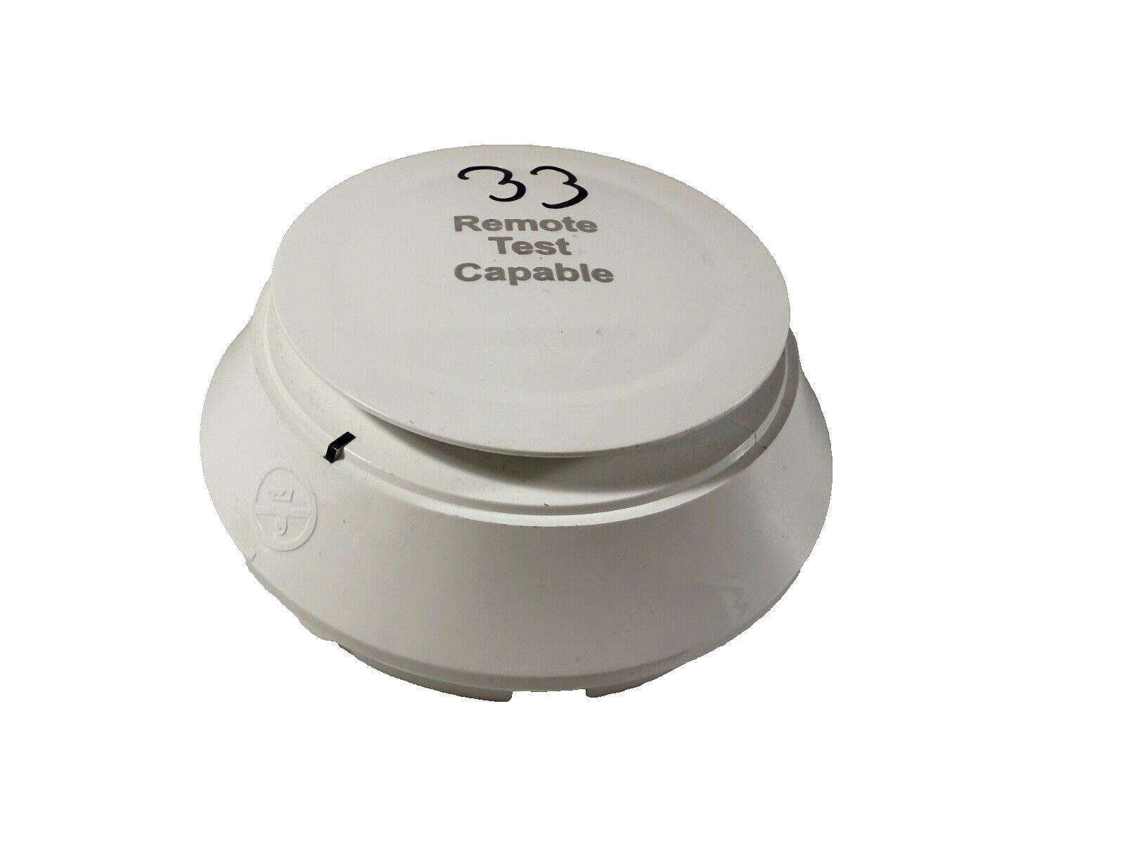 White remote test capable fire alarm device with model 33 label
