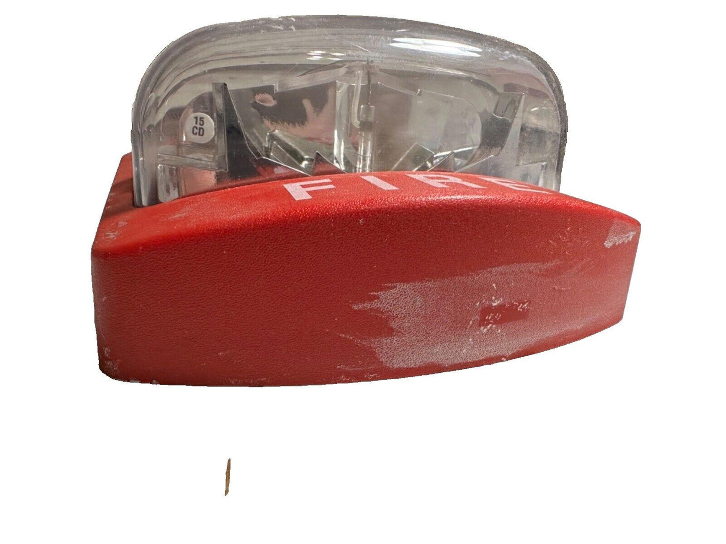 Red fire alarm strobe light with clear lens and visible 15 CD rating, used fire safety equipment