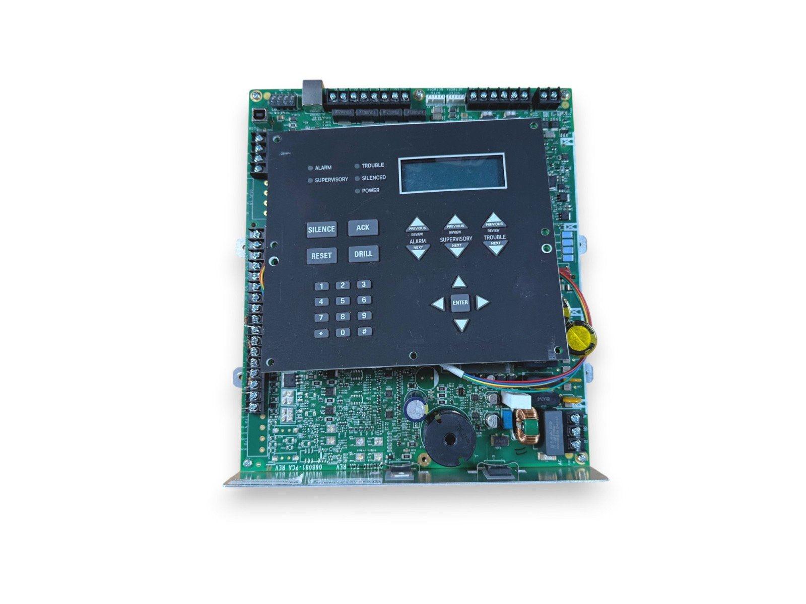 Fire alarm control panel with LCD display, keypad, and status indicators for alarm, trouble, and power