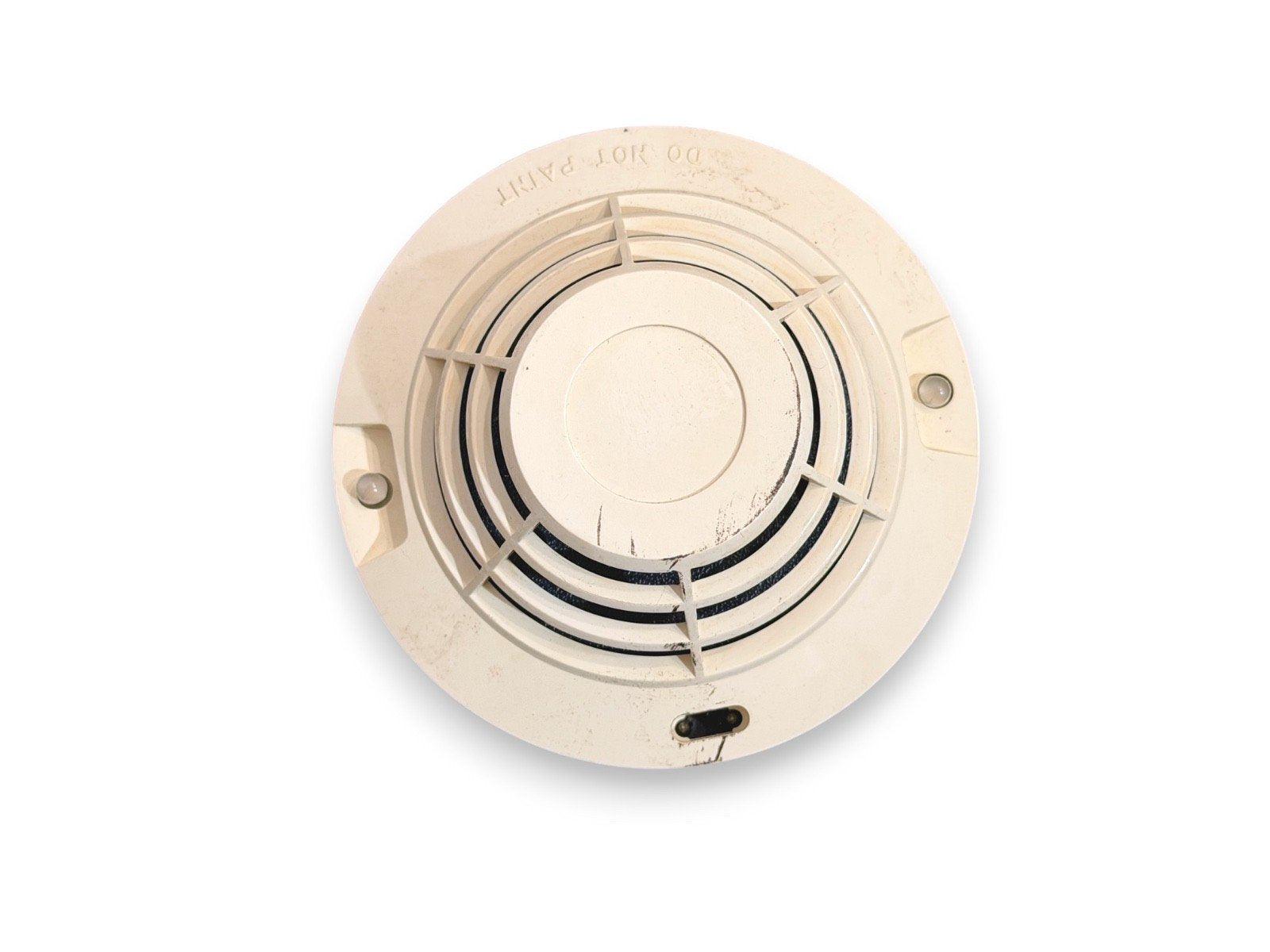 Used fire alarm detector with 'DO NOT PAINT' label, circular design, mounting holes, and sensor grid