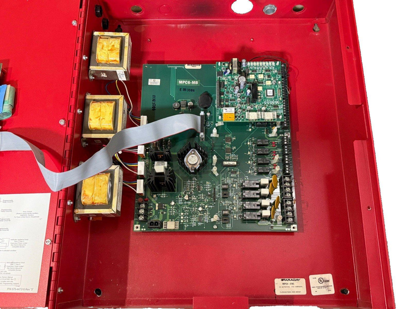 Faraday MPC6-MB fire alarm control panel circuit board with transformers inside red enclosure