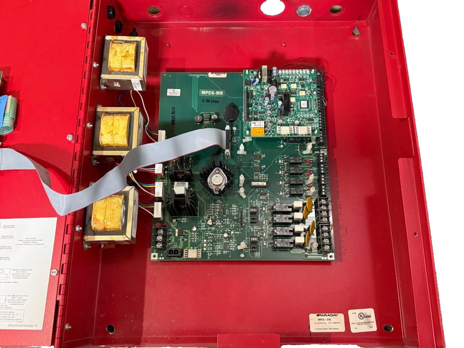 Faraday MPC6-MB fire alarm control panel circuit board with transformers inside red enclosure
