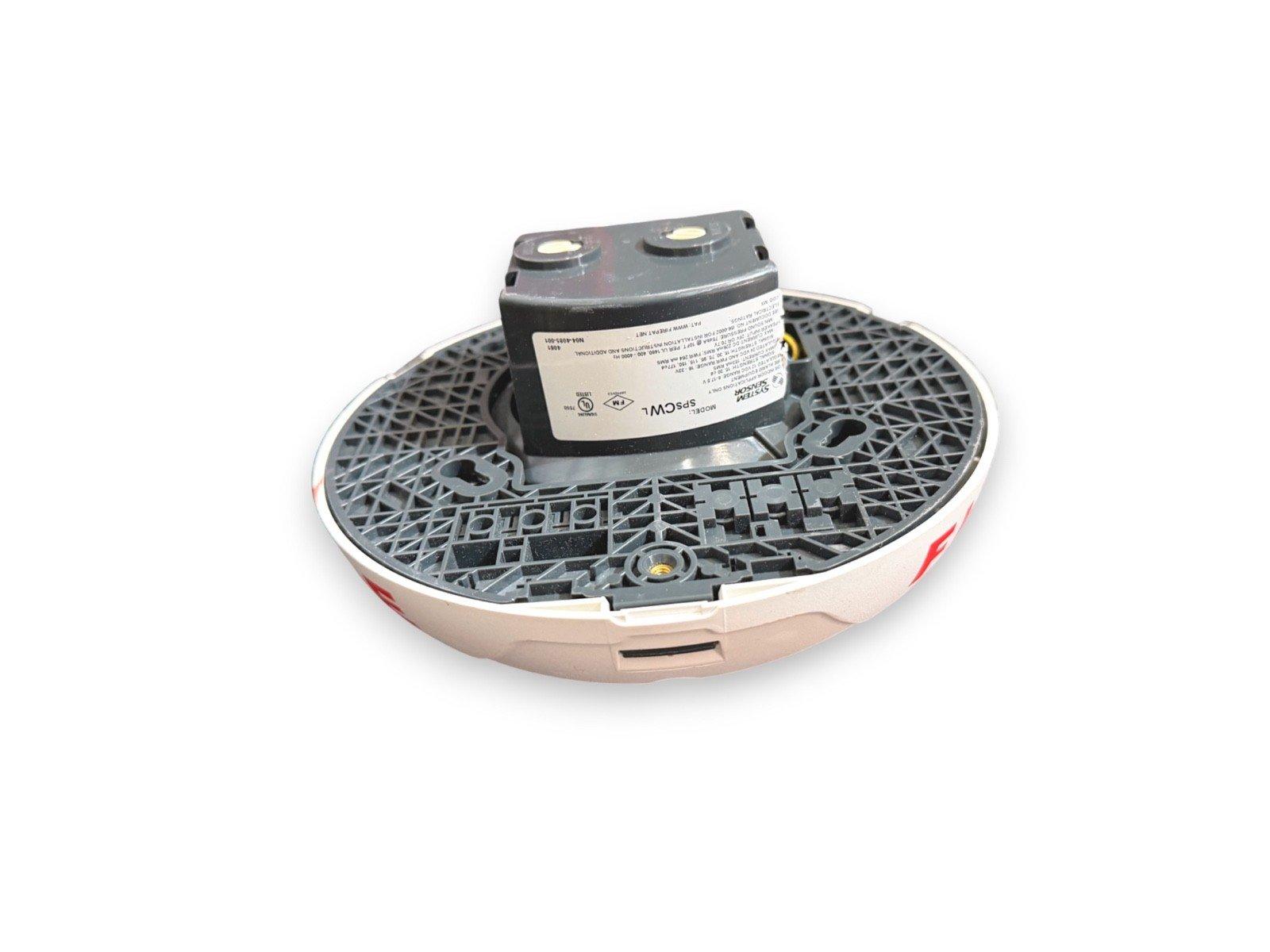System Sensor SPCWL fire alarm detector with mounting base, shown from underside with label and wiring terminals