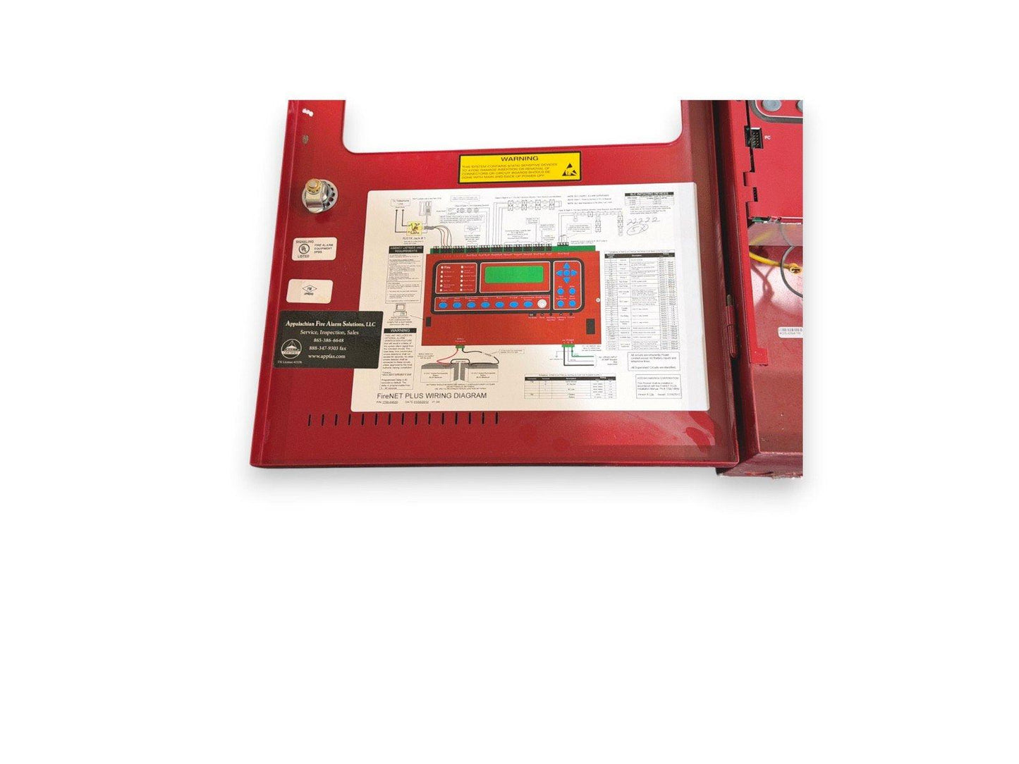 Red fire alarm control panel with wiring diagram and digital display for commercial fire safety systems