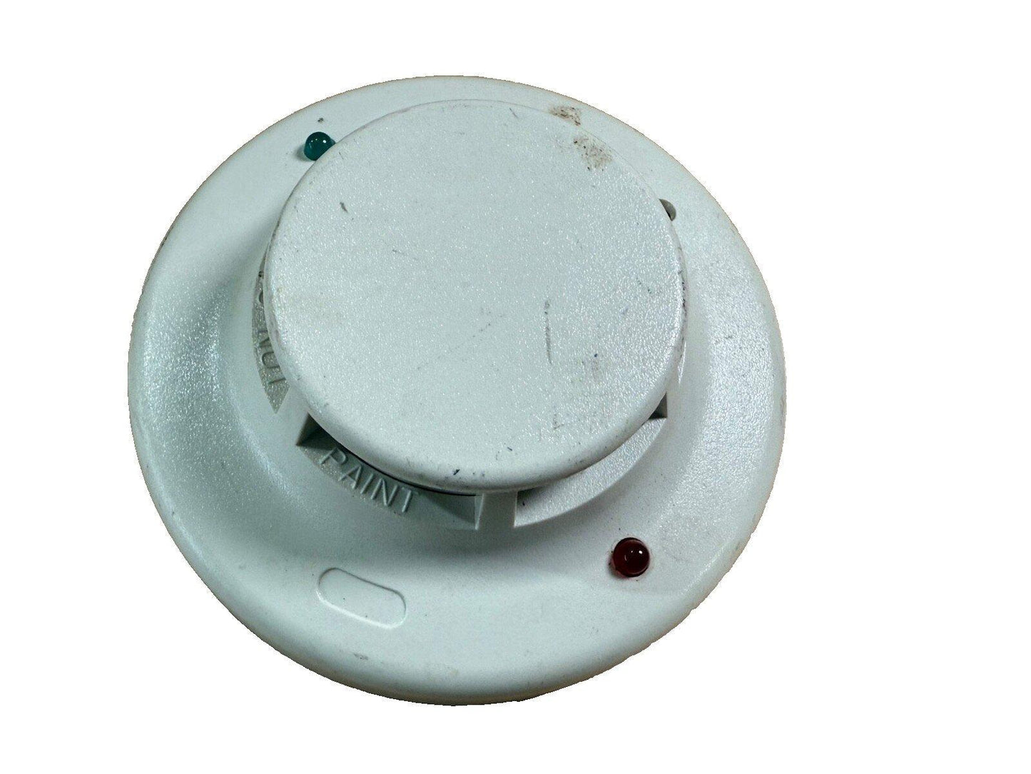 Used white fire alarm smoke detector with green and red indicator lights, showing signs of wear