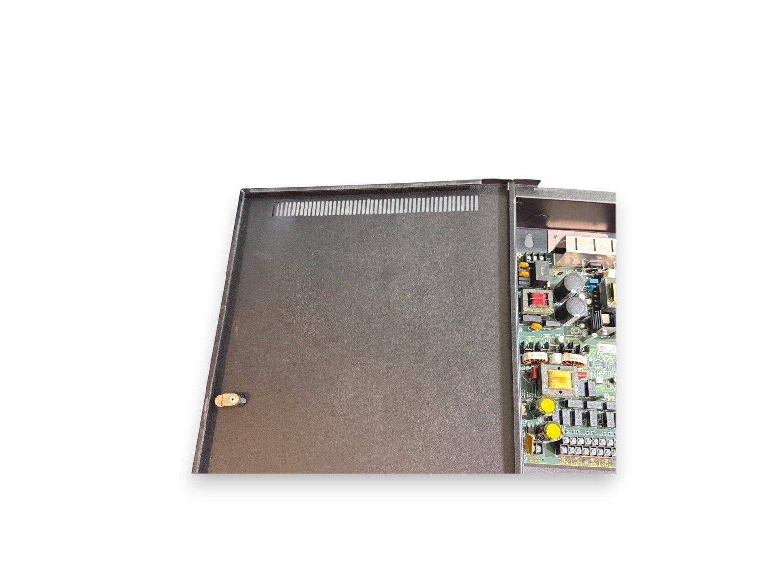 Fire alarm control panel with exposed circuit board and metal enclosure