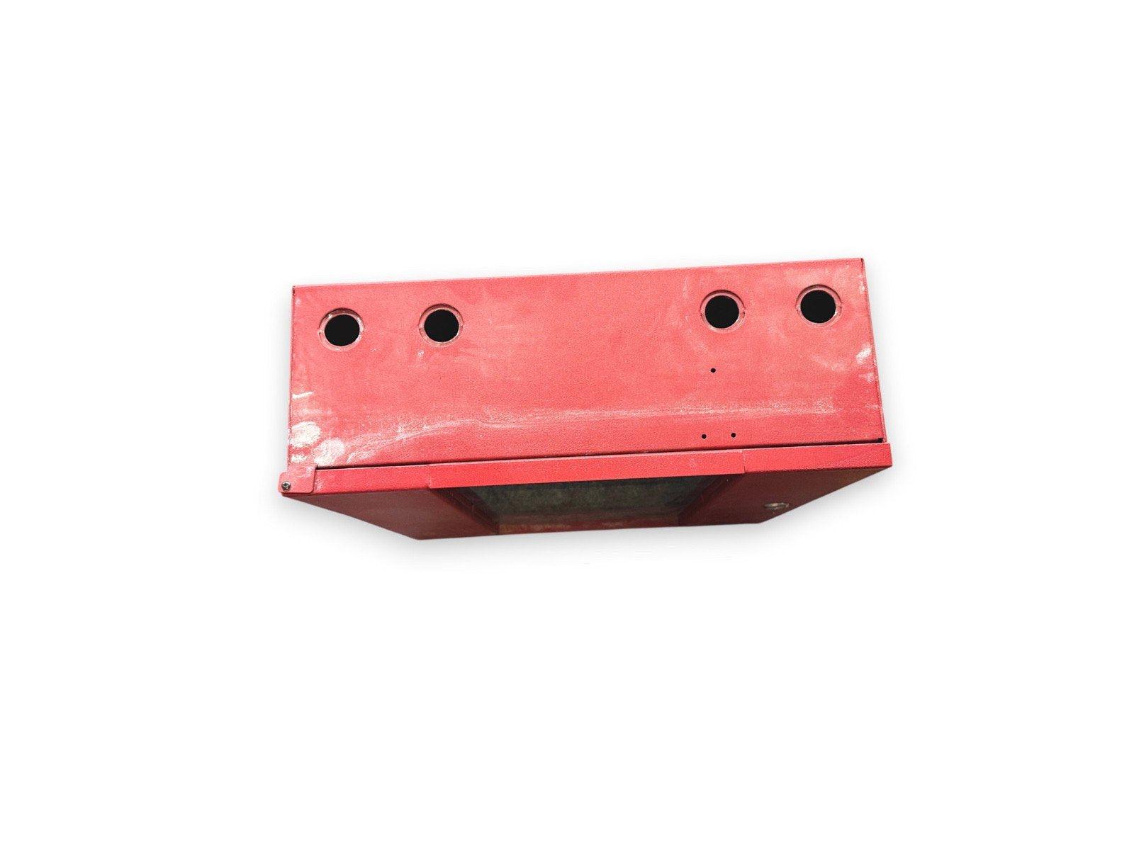 Red fire alarm control panel with four mounting holes, used fire safety equipment